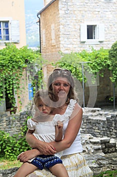 mother hugs serious daughter and calms her down