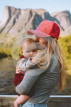 Mother and infant baby together family traveling in mountains