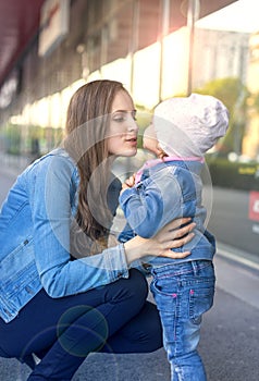 The mother is just about to put her daughter`s kiss.