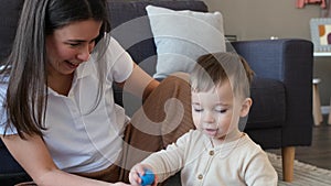 Mother And Kid Boy Spending Pastime With Toys At Home