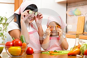 Mother with kid preparing healthy food and having fun
