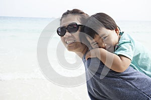 Mother and kid relaxing emotion on sand beach