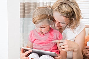 Mother and kid using tablet together