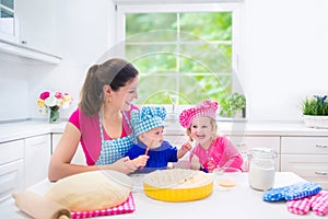 Mother and kids baking a pie