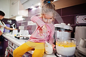 Mother with kids cooking at kitchen, happy children`s moments