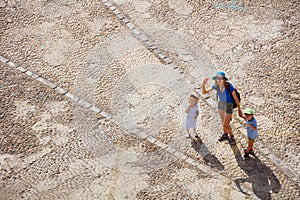 Mother with kids do sightseeing in Spain, view from above