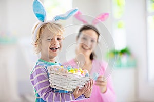 Mother and kids, family coloring Easter eggs