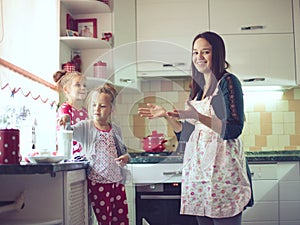 Mother with kids at the kitchen