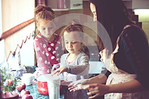 Mother with kids at the kitchen