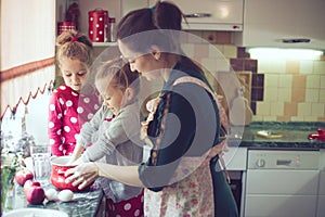 Mother with kids at the kitchen