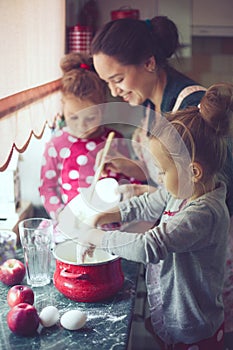 Mother with kids at the kitchen