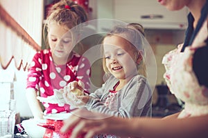 Mother with kids at the kitchen