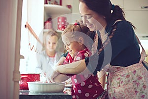 Mother with kids at the kitchen