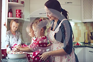 Mother with kids at the kitchen