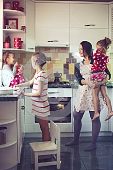 Mother with kids at the kitchen