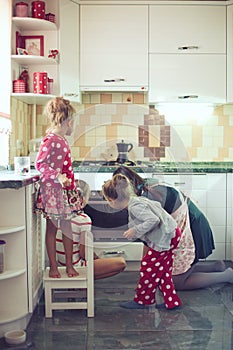 Mother with kids at the kitchen