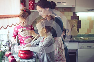 Mother with kids at the kitchen