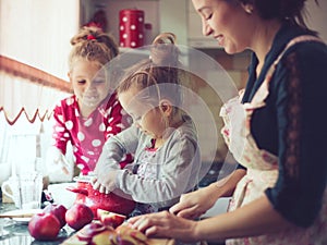 Mother with kids at the kitchen