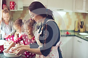 Mother with kids at the kitchen