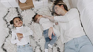 Mother and kids laying on the floor at home