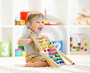 Mother with kids play board game in living room. Family spending time together at home