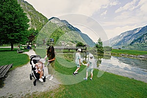 Mother with kids playing in playground at Hallstatt, Austria