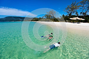 Mother and kids snorkeling