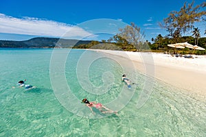 Mother and kids snorkeling