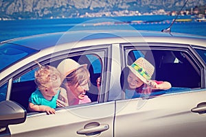 Mother with kids travel by car at the sea