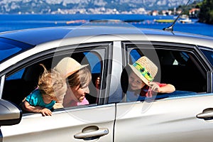 Mother with kids travel by car on sea vacation