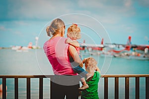 Mother and kids waiting for sea plane, family travel