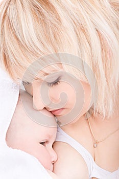 Mother kiss and breast feeding her baby