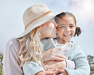 Mother kiss, girl and happy face of a mama and child adoption happiness outdoor for mothers day. Portrait of a hug and