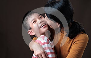 Mother kisses son\'s cheek