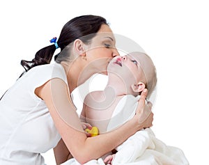 Mother kissing baby girl after bathing