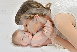 Mother kissing baby with love