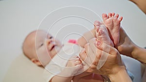 Mother Kissing Baby`s Feet