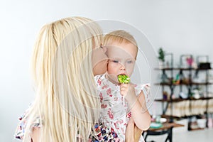 Mother kissing her baby`s. Mother holding infant`s. Portrait of a mother with baby at home.