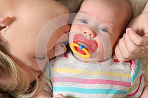 Mother kissing her little baby