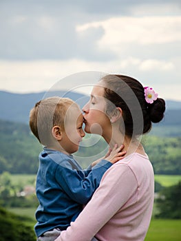 Mother kissing her son