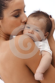 Mother kissing newborn baby