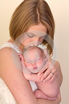 Mother kissing newborn child