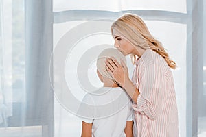 Mother kissing sick child in head