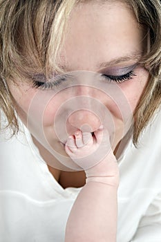 Mother kissing the tootsie of her baby