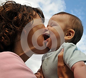 Mother kissing young baby