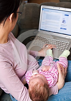 Mother with laptop and baby