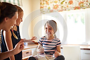 Mother laughing, happy family or kids baking in kitchen with siblings learning or mixing cookies recipe. Funny, home or