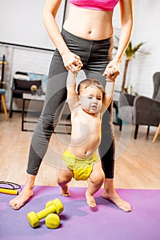 Mother learning her baby son to walk