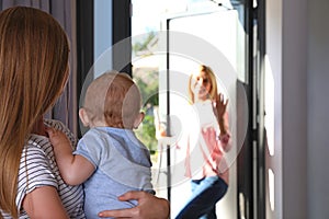 Mother leaving her baby with teen nanny photo