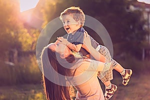 Mother lifting son